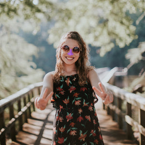 Woman with sunglasses wearing Noz reef safe sunscreen with best spf for sunscreen